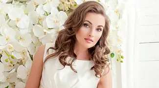 Woman beside white flowers representing a profile introduction